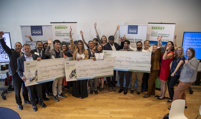 The winning Collegiate Track teams celebrate alongside DOE, NREL, and CEBN staff.